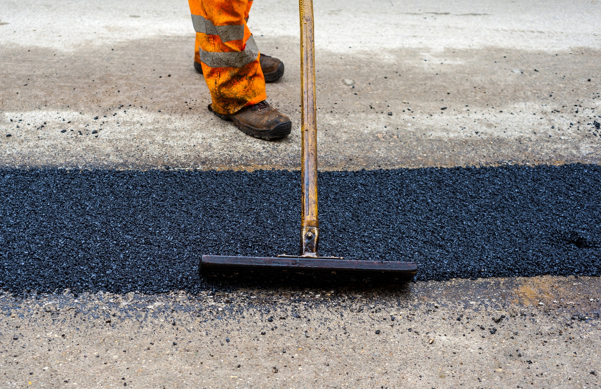 Construction Worker During Asphalting Road Works.